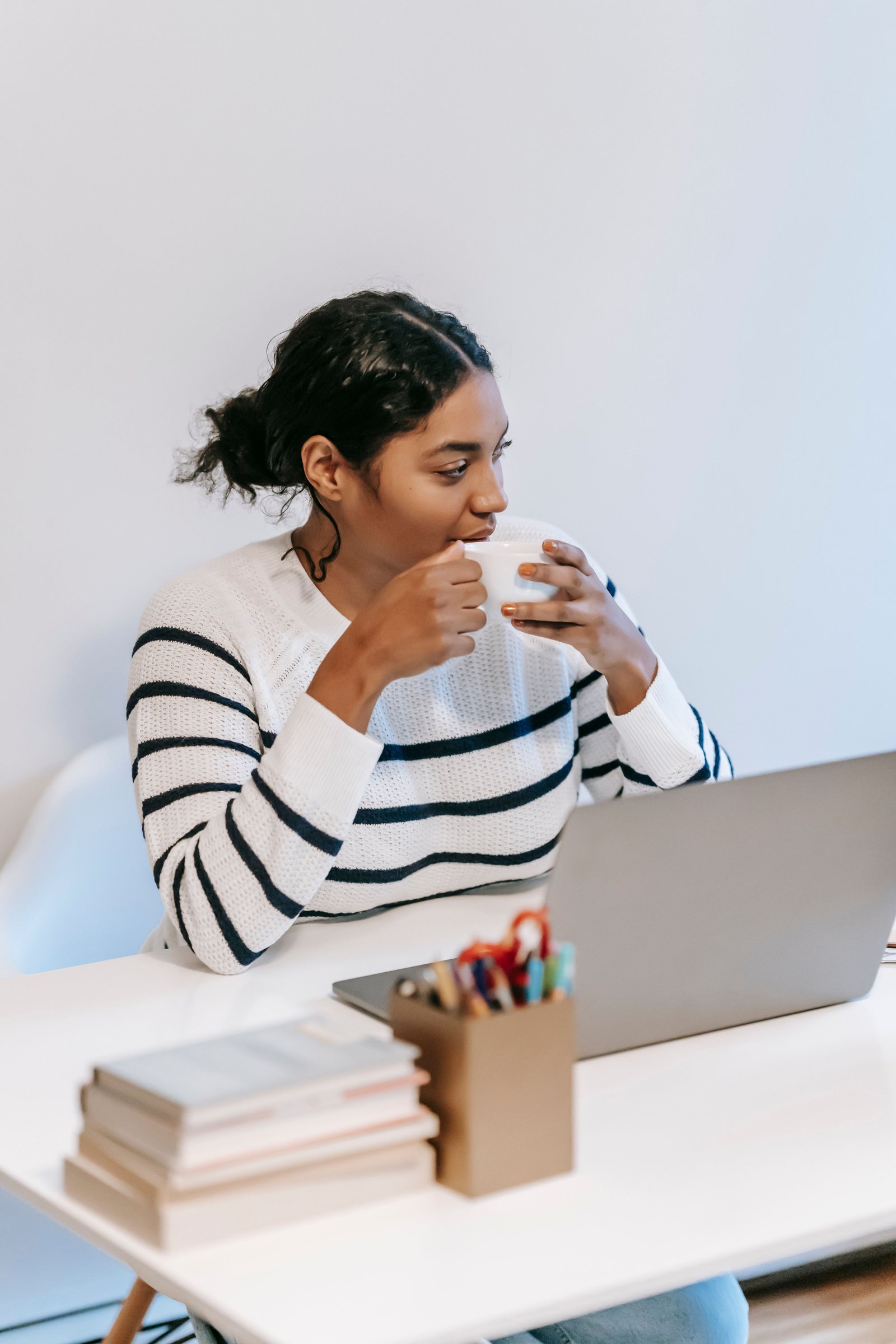 An Indian woman working remotely from home on her laptop